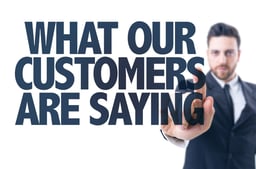 Business man pointing the text What Our Customers Are Saying.jpeg