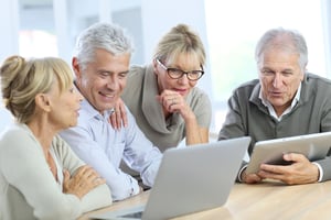 Group of retired senior people using laptop and tablet