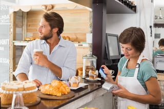 Pretty waitress serving happy customer at the coffee shop.jpeg