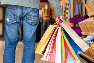 casual man carrying shopping bags in a store.jpeg