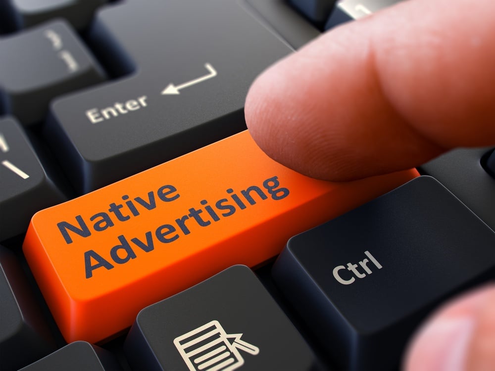Native Advertising Button. Male Finger Clicks on Orange Button on Black Keyboard. Closeup View. Blurred Background..jpeg