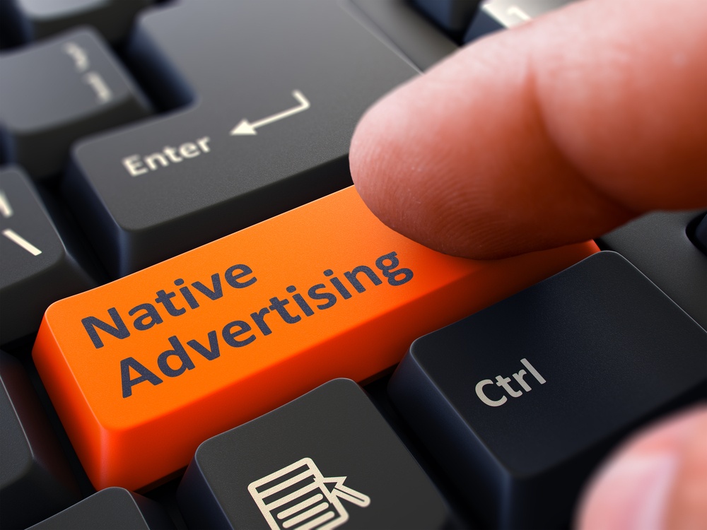 Native Advertising Button. Male Finger Clicks on Orange Button on Black Keyboard. Closeup View. Blurred Background..jpeg